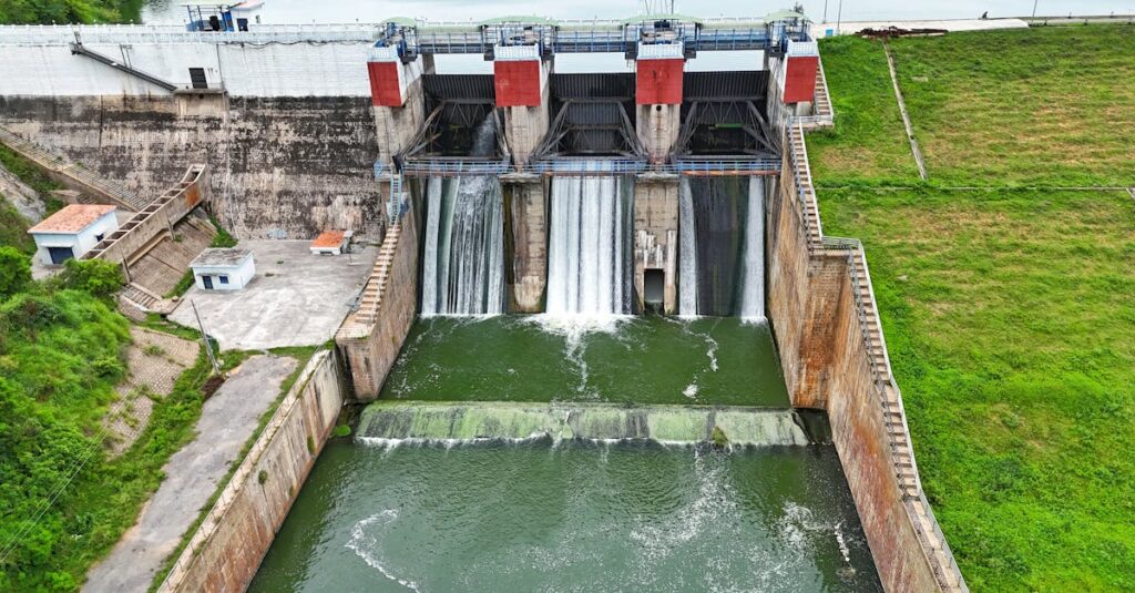 A stunning aerial photo of a hydroelectric dam with flowing water and lush surroundings.